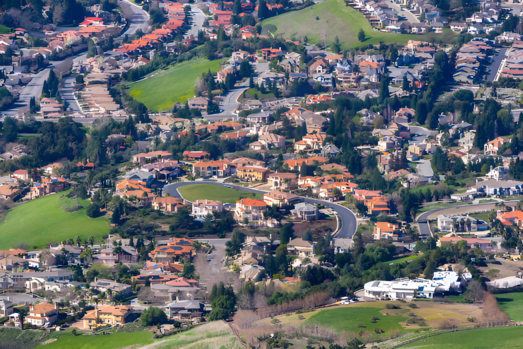 An aerial view of a residential community in Fremont, California, showcasing modern homes and tree-lined streets.