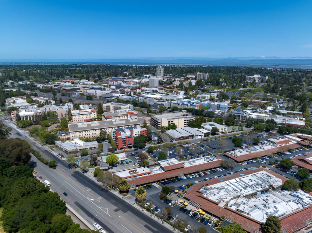 Aerial view of Menlo Park, CA, showcasing residential neighborhoods and the surrounding Silicon Valley landscape.
