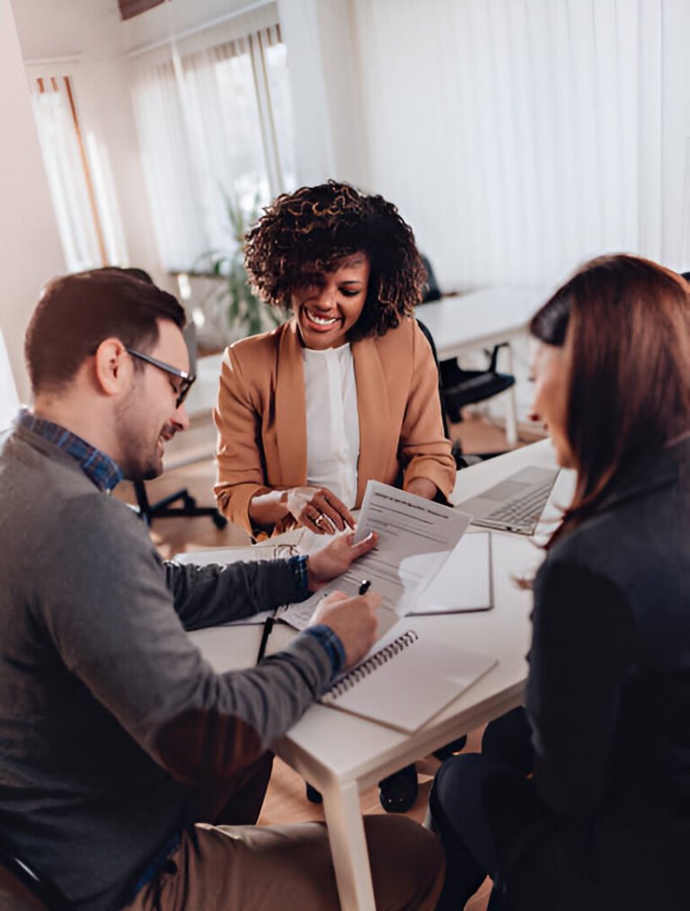 A couple signing a loan agreement at the bank, securing home insurance for their residential real estate in the San Francisco Bay Area.